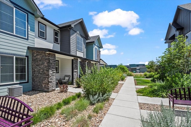 19592 W 93rd Pl Unit C, Arvada, CO 80007 - view of side of property featuring a central air condition unit and stone siding
