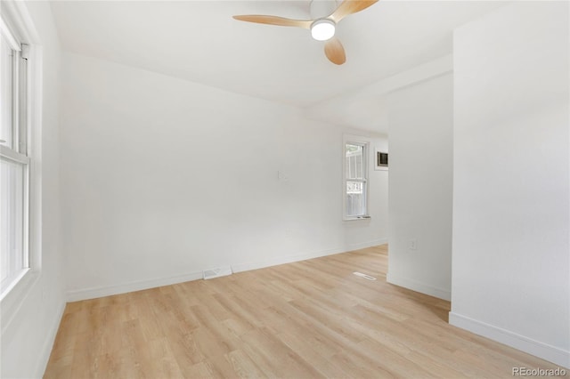 spare room with light wood-type flooring and ceiling fan