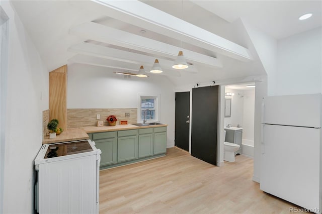 kitchen with sink, range, white fridge, light hardwood / wood-style floors, and tasteful backsplash