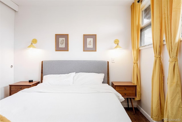 bedroom with wood finished floors and baseboards