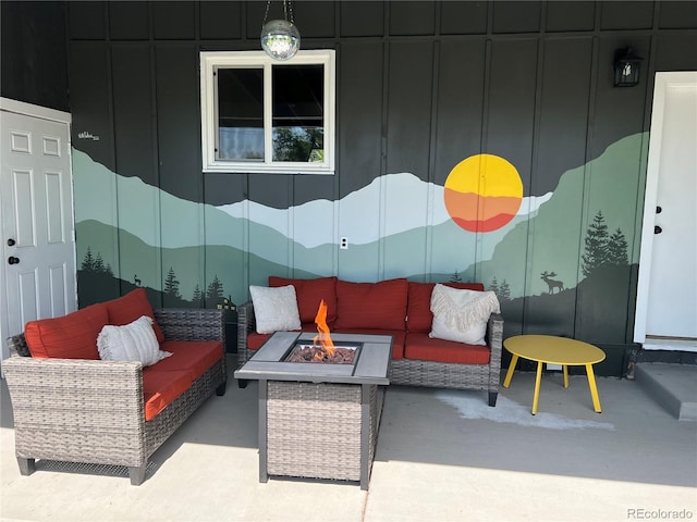 view of patio with an outdoor living space with a fire pit