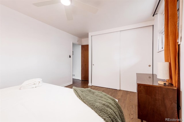 bedroom featuring a closet, a ceiling fan, and wood finished floors