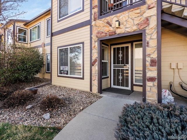 property entrance featuring stone siding