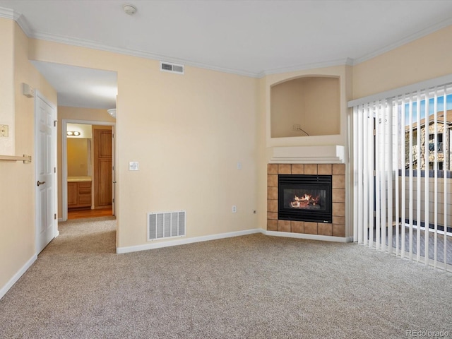 unfurnished living room with visible vents, crown molding, and carpet floors