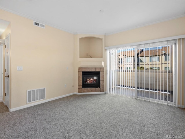 unfurnished living room with visible vents, crown molding, and carpet