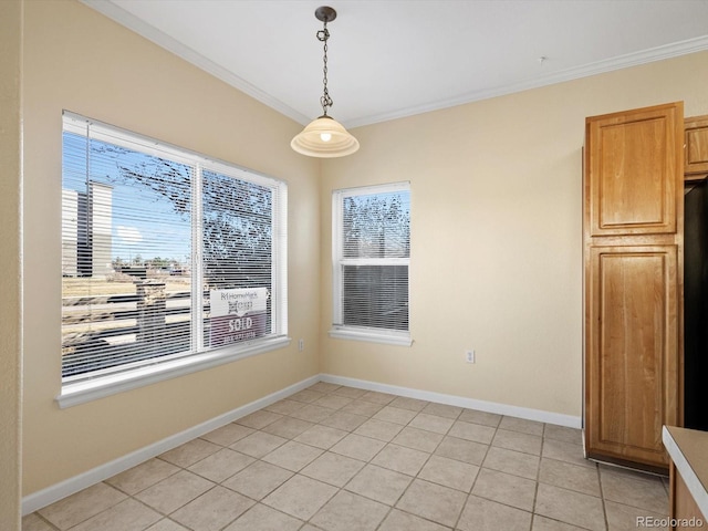 unfurnished dining area with light tile patterned floors, baseboards, a wealth of natural light, and ornamental molding