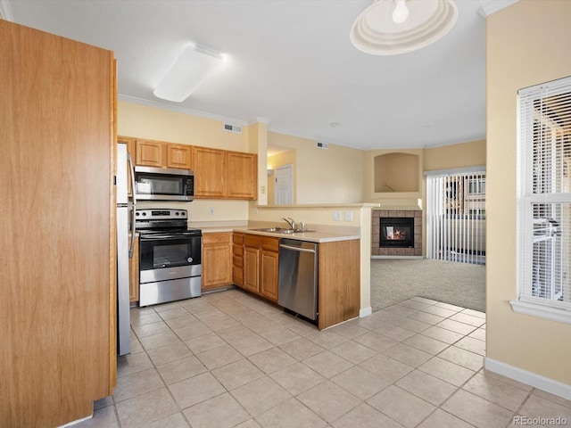 kitchen with a wealth of natural light, stainless steel appliances, visible vents, and open floor plan