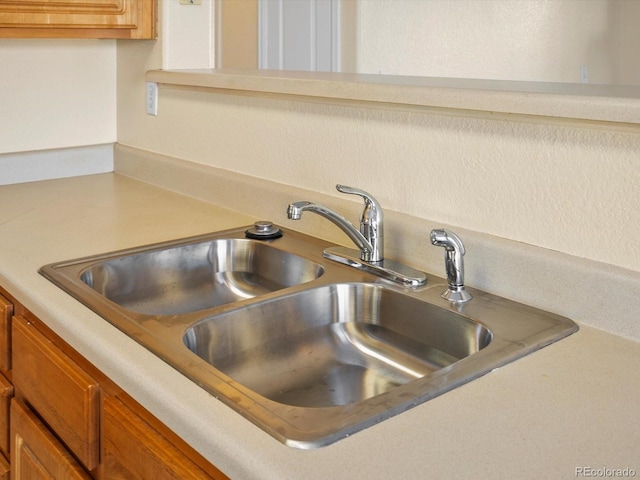 interior details featuring brown cabinets, light countertops, and a sink