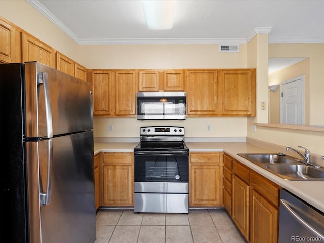 kitchen featuring visible vents, appliances with stainless steel finishes, light countertops, and a sink