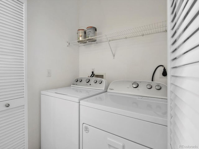 laundry area featuring washer and clothes dryer and laundry area