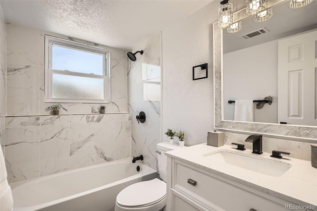 17979 E Oxford Pl, Aurora, CO 80013 - bathroom with vanity, toilet, bathtub / shower combination, a textured wall, and a textured ceiling