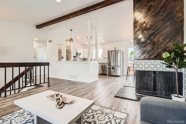 17979 E Oxford Pl, Aurora, CO 80013 - living area with light wood finished floors, recessed lighting, baseboards, and a brick fireplace