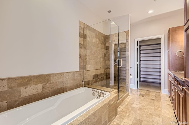 bathroom featuring vanity and separate shower and tub