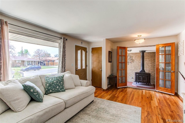 2785 Skyline Dr, Westminster, CO 80030 - living room featuring a wood stove, light wood-type flooring, and french doors
