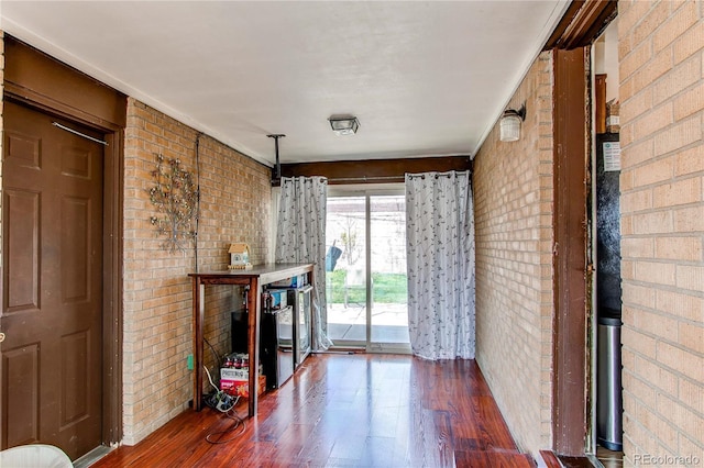 2785 Skyline Dr, Westminster, CO 80030 - unfurnished living room featuring brick wall and wood finished floors