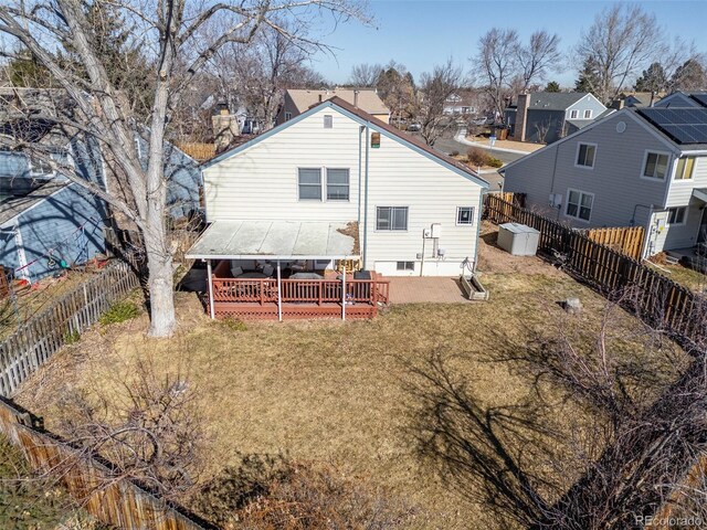 rear view of house featuring a residential view, a lawn, a patio, and a fenced backyard