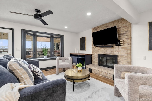 living room with recessed lighting, wood finished floors, a fireplace, and ceiling fan