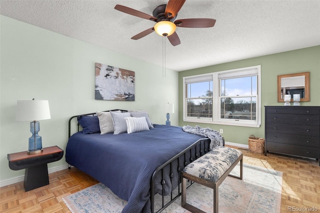 bedroom featuring a textured ceiling, baseboards, and a ceiling fan