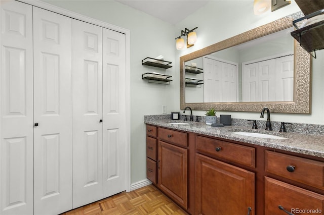 full bathroom featuring a closet, double vanity, and a sink