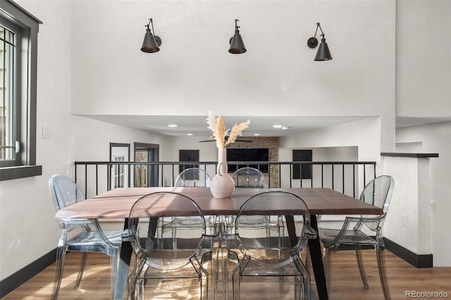 dining area with baseboards and wood finished floors