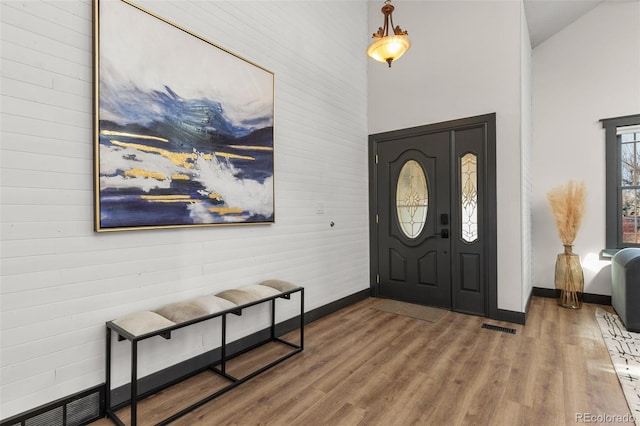 entryway with wood finished floors, visible vents, and baseboards