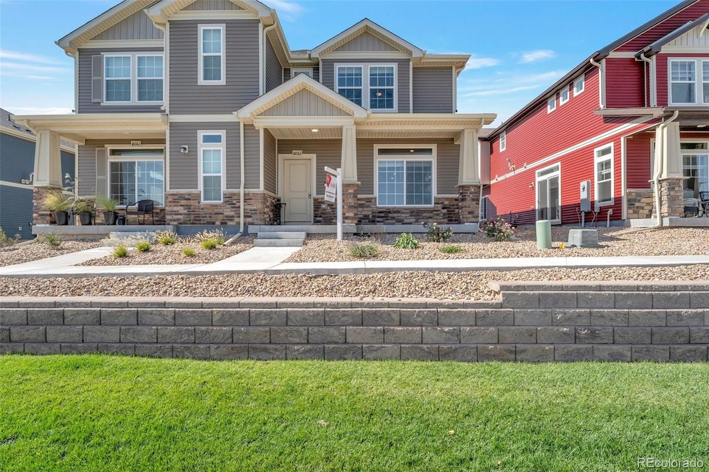 craftsman inspired home with a porch and a front lawn