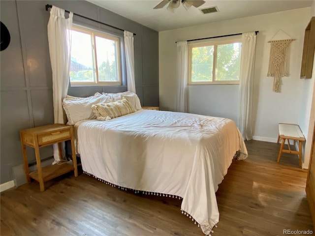 bedroom featuring ceiling fan and dark hardwood / wood-style flooring