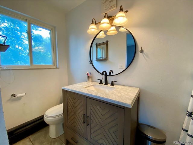 bathroom featuring vanity, toilet, and tile patterned flooring