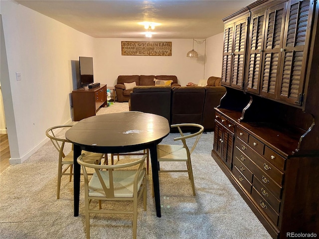 dining room featuring light carpet