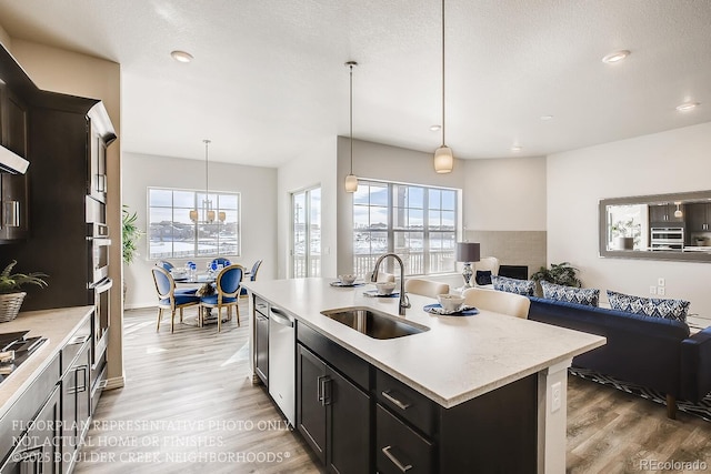 917 W 129th Pl, Denver, CO 80234 - kitchen featuring a sink, wood finished floors, light countertops, healthy amount of natural light, and recessed lighting
