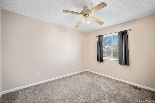 unfurnished room featuring ceiling fan, carpet floors, and a textured ceiling