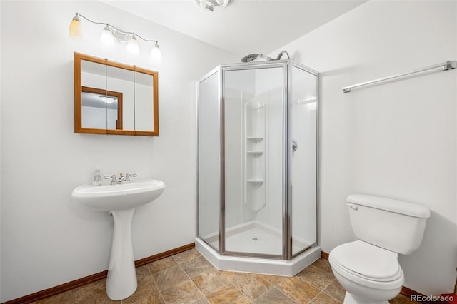 bathroom featuring an enclosed shower and toilet