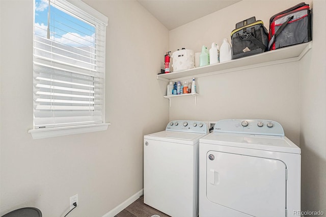 washroom with laundry area, separate washer and dryer, wood finished floors, and baseboards