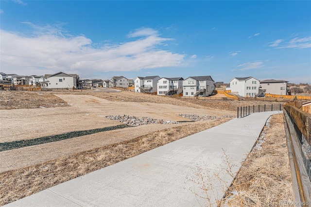view of yard featuring fence and a residential view