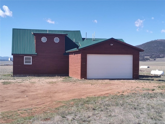 view of front of property featuring a garage and a mountain view