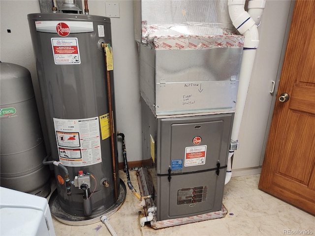 utility room featuring water heater and heating utilities