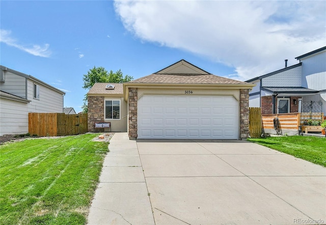 5056 E 112th Ct, Thornton, CO 80233 - view of front of property featuring stone siding, concrete driveway, roof with shingles, and an attached garage