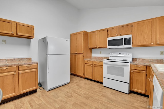 5056 E 112th Ct, Thornton, CO 80233 - kitchen with white appliances, high vaulted ceiling, tile counters, and light wood finished floors