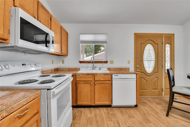 5056 E 112th Ct, Thornton, CO 80233 - kitchen featuring white appliances, light wood-style flooring, and brown cabinetry