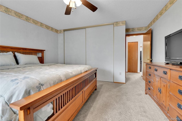 5056 E 112th Ct, Thornton, CO 80233 - bedroom featuring light carpet, a closet, a textured ceiling, and a ceiling fan