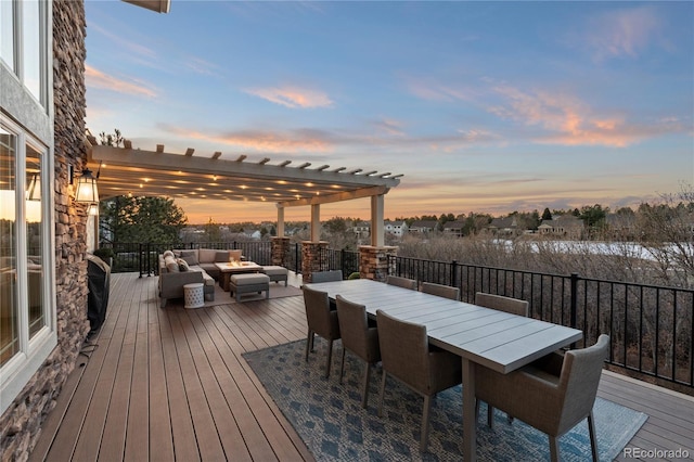 deck at dusk featuring outdoor dining space, an outdoor hangout area, and a pergola