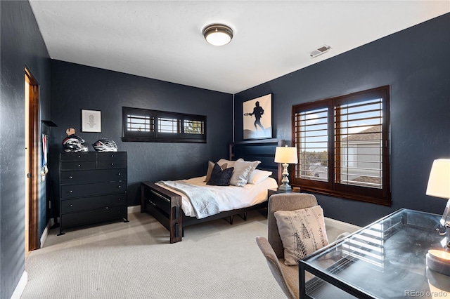 bedroom featuring visible vents, carpet flooring, and baseboards