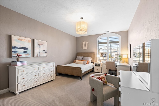 bedroom with visible vents, light colored carpet, a textured wall, a notable chandelier, and a textured ceiling