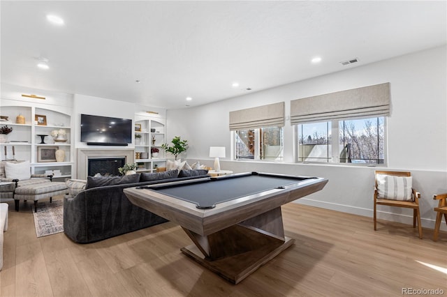 recreation room featuring visible vents, light wood-style flooring, recessed lighting, a fireplace, and pool table