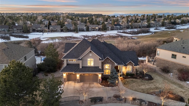 snowy aerial view with a residential view