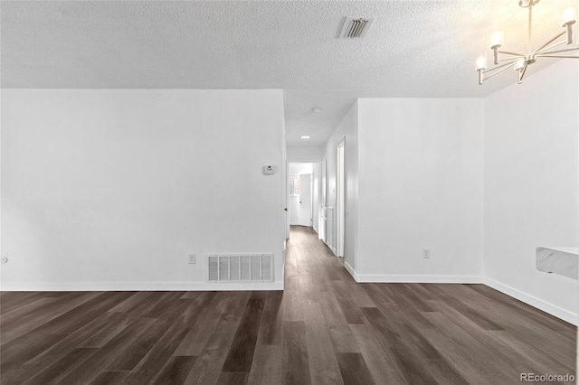7220 S Gaylord St Unit G17, Littleton, CO 80122 - spare room with a chandelier, dark wood-type flooring, baseboards, and a textured ceiling