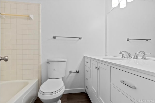 7220 S Gaylord St Unit G17, Littleton, CO 80122 - full bathroom featuring baseboards, vanity, toilet, and wood finished floors