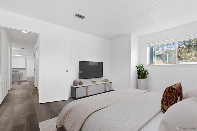 7220 S Gaylord St Unit G17, Littleton, CO 80122 - bedroom featuring wood finished floors and a textured ceiling