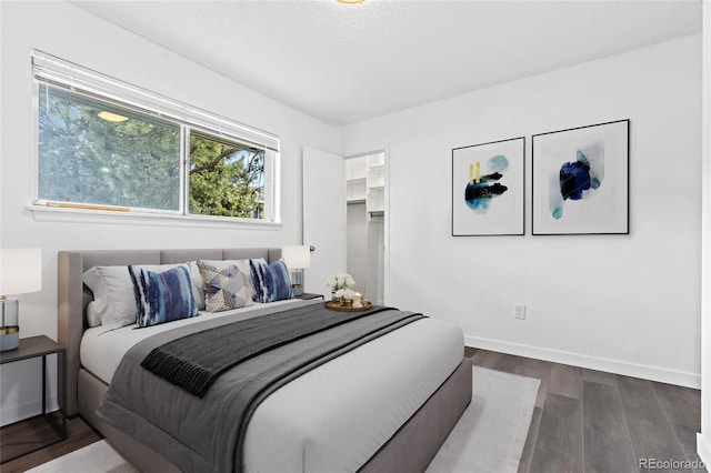 7220 S Gaylord St Unit G17, Littleton, CO 80122 - bedroom featuring wood finished floors, baseboards, and a spacious closet