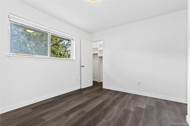 7220 S Gaylord St Unit G17, Littleton, CO 80122 - unfurnished bedroom featuring dark wood-style floors and baseboards